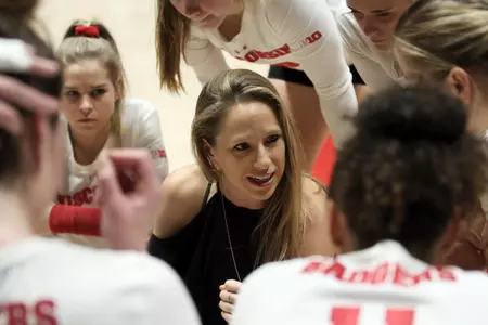 Brittany Dildine talks to players in a huddle