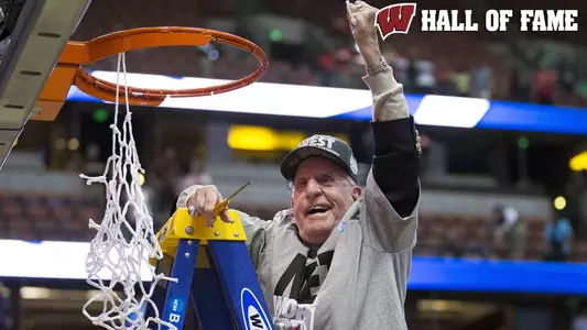 Otto Puls cutting down the net men's basketball