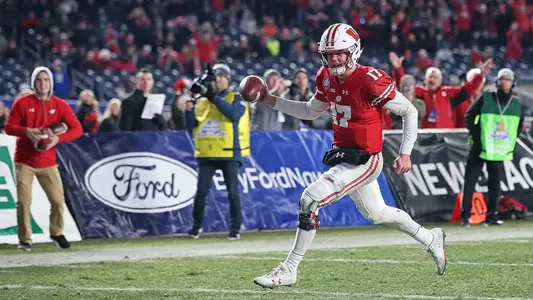 Jack Coan runs in a touchdown against Miami during the 2018 New Era Pinstripe Bowl