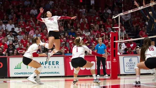 Molly Haggerty hits against two Washington blockers.