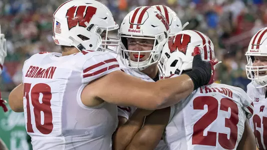 Wisconsin Badgers running back Jonathan Taylor (23) celebrates a touchdown with teammates Jack Coan and Jason Erdmann during an NCAA college football game against the USF Bulls Saturday, Sept. 30, 2019, in Tampa Bay, Florida. The Badgers won 49-0. (Photo by David Stluka/Wisconsin Athletic Communications)