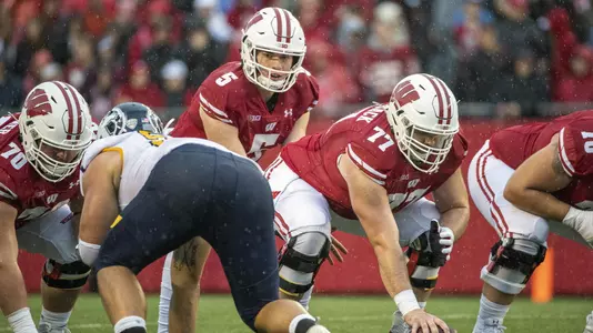 Wisconsin Badgers quarterback Graham Mertz (5) lines up under center Blake Smithback (77) during an NCAA college football game against the Kent State Golden Flashes Saturday, Oct. 5, 2019, in Madison, Wis. The Badgers won 48-0. (Photo by David Stluka/Wisconsin Athletic Communications)