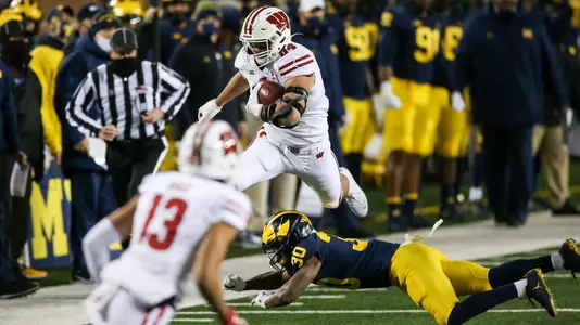 Wisconsin Badgers' tight end Jake Ferguson (84) hurdles a defender during an NCAA college football game against the Michigan Wolverines Saturday, Nov. 14, 2020, in Ann Arbor, Mich. The Badgers won 49-11. (Photo by Darren Lee/Wisconsin Athletic Communications)