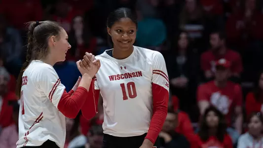 Devyn Robinson and Izzy Ashburn celebrate on the court.