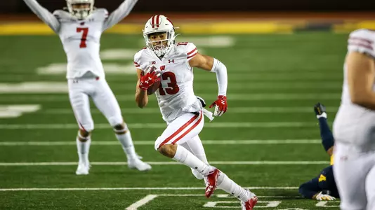 Wisconsin Badgers' wide receiver Chimere Dike (13) runs the ball during an NCAA college football game against the Michigan Wolverines Saturday, Nov. 14, 2020, in Ann Arbor, Mich. The Badgers won 49-11. (Photo by Darren Lee/Wisconsin Athletic Communications)