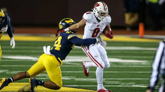 Wisconsin Badgers' running back Jalen Berger (8) breaks a tackle during an NCAA college football game against the Michigan Wolverines Saturday, Nov. 14, 2020, in Ann Arbor, Mich. The Badgers won 49-11. (Photo by Darren Lee/Wisconsin Athletic Communications)