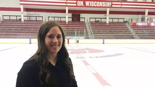 Emily Engel-Natzke Wisconsin men's hockey standing by ice rink