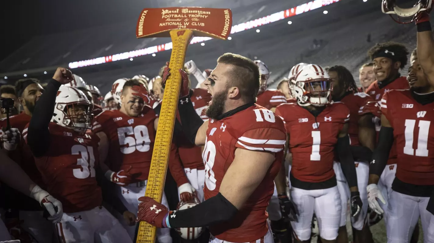Wisconsin Badgers Collin Wilder chops down the goalpost with Paul Bunyan's Axe after an NCAA college football game against the Minnesota Golden Gophers Saturday, Dec. 19, 2020, in Madison, Wis. (Photo by David Stluka/Wisconsin Athletic Communications)