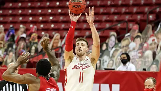 Micah Potter men's basketball shoots a 3-pointer against Louisville at the Kohl Center on Saturday, Dec. 19, 2020