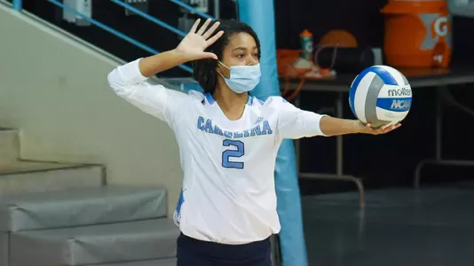 Sydney Reed serves the volleyball