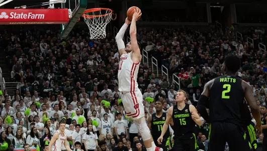 Micah Potter dunks the ball against Michigan State
