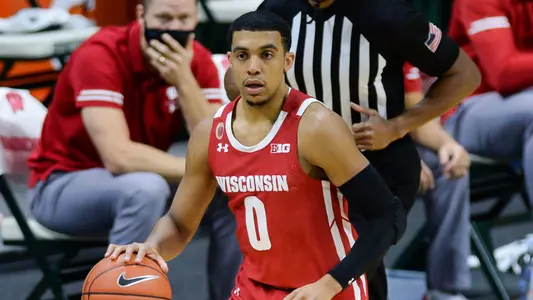 Wisconsin Badgers guard D'Mitrik Trice (0) dribbles the ball up court during a college basketball game between the Michigan State Spartans and the Wisconsin Badgers on December 25, 2020 at the Breslin Student Events Center in East Lansing, MI.(Photo by Adam Ruff/Icon Sportswire)