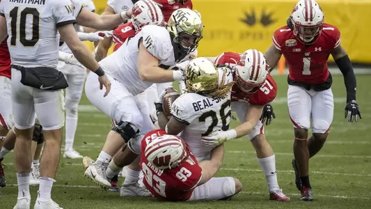 Wisconsin Badgers Jack Sanborn (57) and Garrett Rand (93) tackle Wake Forest running back Christian Beal-Smith (26) during an NCAA Duke’s Mayo Bowl college football game against the Wake Forest Damon Deacons Wednesday, Dec. 30, 2020, in Charlotte, NC. (Photo by David Stluka/Wisconsin Athletic Communications)