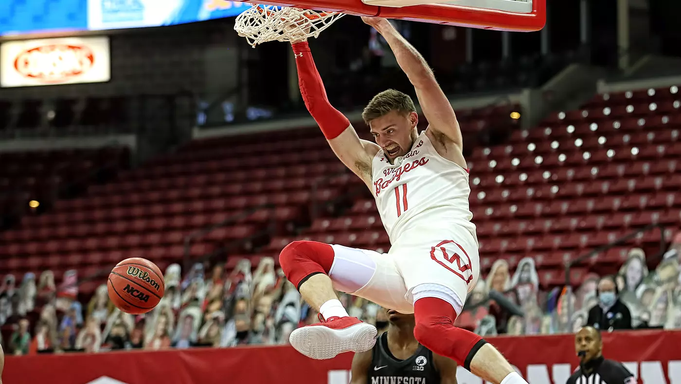Micah Potter finishes a dunk vs. Minnesota
