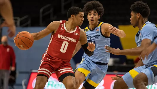 D'Mitrik Trice drives the ball during a game at Marquette