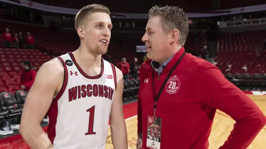 Brevin Pritzl men's basketball with alumni Jon Bryant talking post-game following Wisconsin's 70-57 win against Ohio State at the Kohl Center on Sunday, Feb. 9, 2020. Alumni of the 1999-2000 team were present to celebrate the 20th anniversary of the run to the 2000 NCAA Final Four.