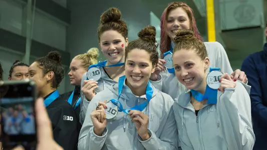 400 medley relay team pose with medals