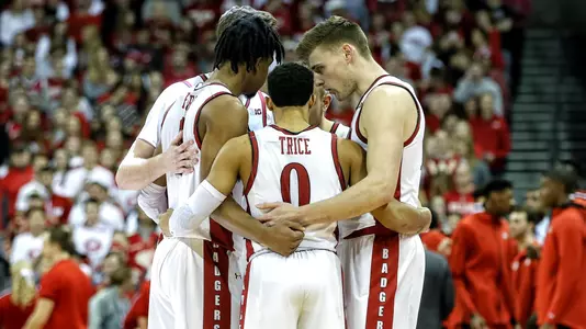D'Mitrik Trice, Aleem Ford, Micah Potter and Wisconsin teammates huddle during a men's basketball game vs. Ohio State on Feb. 9, 2020 at the Kohl Center