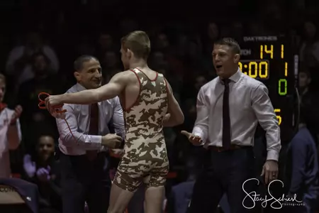 Seth Gross hugs coach Chris Bono with coach Jon Reader