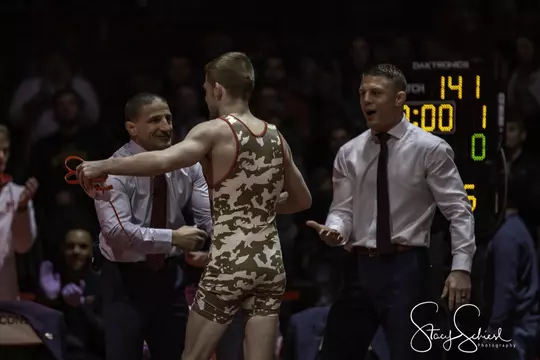Seth Gross hugs coach Chris Bono with coach Jon Reader