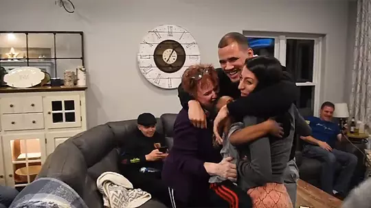 Zack Baun hugs his family after hearing his NFL draft announcement