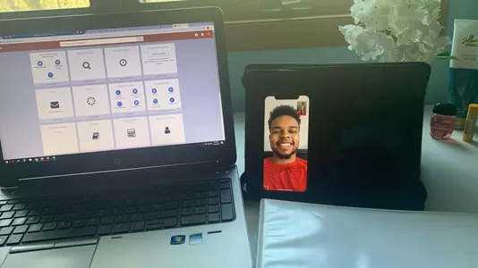 Computer screen for academic services and FaceTime call with football student-athletes