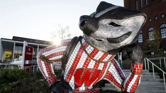"Well Red," a sculpture by artist Douwe Blumberg of a studious-looking UW-Madison mascot Bucky Badger sitting atop a pile of books, is pictured at Alumni Park at the University of Wisconsin-Madison during the autumn morning of Oct. 8, 2017. The newly-opened park, part of the Wisconsin Alumni Association (WAA), is located between the Memorial Union and Red Gym (Armory and Gymnasium) overlooking the Lake Mendota shoreline. In the background at left is One Alumni Place. (Photo by Jeff Miller / UW-Madison)