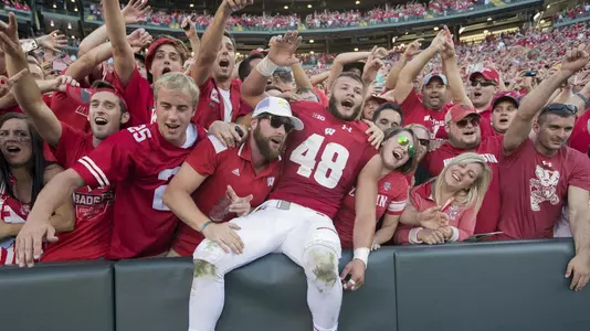 Wisconsin Badgers linebacker Jack Cichy (48) does a Lambeau Leap while celebrating with fans during an NCAA college football game against the LSU Tigers Saturday, September 3, 2016, in Green Bay, Wis. The Badgers beat the Tigers 16-14. (Photo by David Stluka)