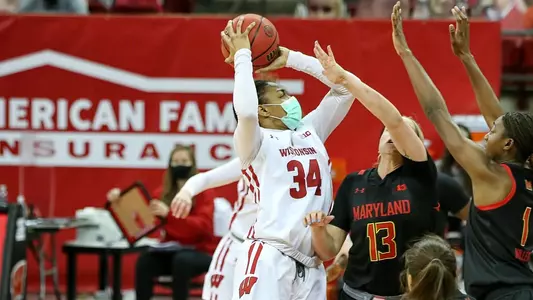 Imani Lewis shoots over two Maryland defenders.