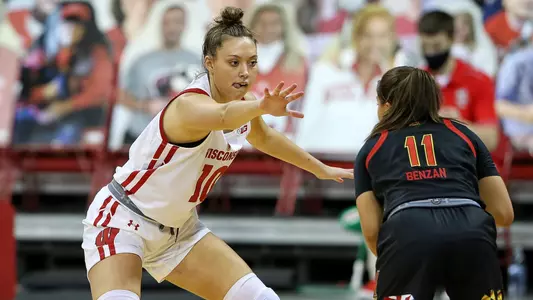 Halle Douglass plays defense against a Maryland player.