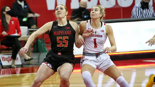 Estella Moschkau battles for a rebound against  Maryland player.
