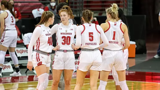 The Badgers huddle up on the court against Maryland.