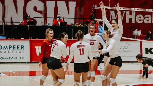 The Badgers celebrate a point during the match.