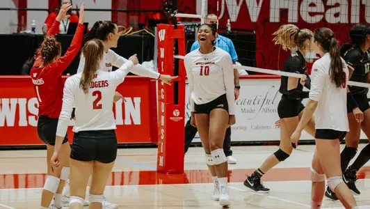 The Badgers celebrate a point during the match.