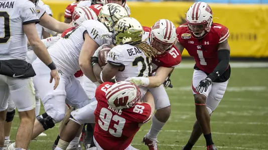 Wisconsin Badgers defensive lineman Garrett Rand (93) and linebacker Jack Sanborn (57) make a tackle during an NCAA college football game at the Duke’s Mayo Bowl against the Wake Forest Demon Deacons Wednesday, Dec. 30, 2020, in Charlotte, NC. The Badgers won 42-28. (Photo by David Stluka/Wisconsin Athletic Communications)