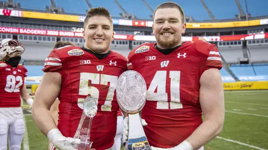 Wisconsin Badgers linebackers Jack Sanborn (57) and Noah Burks (41) celebrate with the trophy after an NCAA college football game at the Duke’s Mayo Bowl against the Wake Forest Demon Deacons Wednesday, Dec. 30, 2020, in Charlotte, NC. The Badgers won 42-28. (Photo by David Stluka/Wisconsin Athletic Communications)