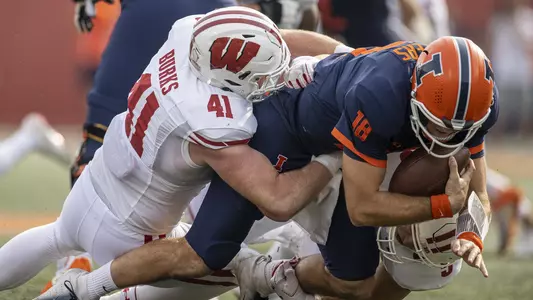 Wisconsin Badgers linebackers Noah Burks (41) and Leo Chenal (5) sack Illinois Fighting Illini quarterback Brandon Peters (18) during an NCAA college football game, Saturday, Oct. 9, 2021, in Champaign, Ill. The Badgers won 24-0. (Photo by David Stluka/Wisconsin Athletic Communications)