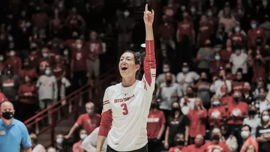 Anna MacDonald celebrates by pointing her finger in the air