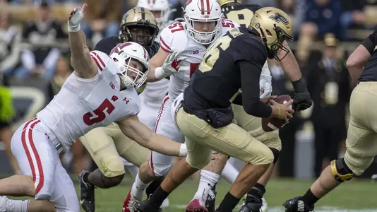 Wisconsin Badgers Leo Chenal (5) sacks the Purdue quarterback during an NCAA college football game against the Purdue Boilermakers, Saturday, Oct. 23, 2021, in West Lafayette, Ind. (Photo by David Stluka/Wisconsin Athletic Communications)