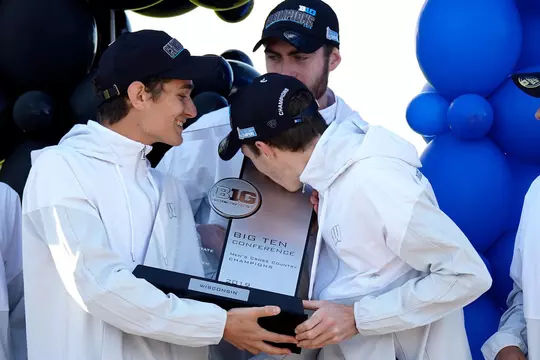 Olin Hacker and teammates kiss 2019 Big Ten Cross Country Championship trophy