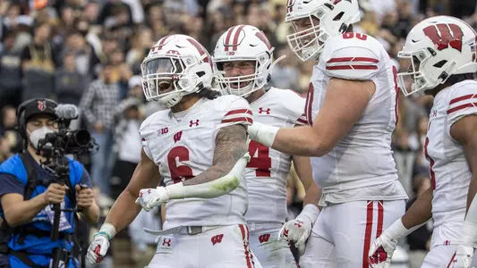 Wisconsin Badgers running back Chez Mellusi (6) celebrates a touchdown with teammates during an NCAA college football game against the Purdue Boilermakers, Saturday, Oct. 23, 2021, in West Lafayette, Ind. The Badgers won 30-13. (Photo by David Stluka/Wisconsin Athletic Communications)