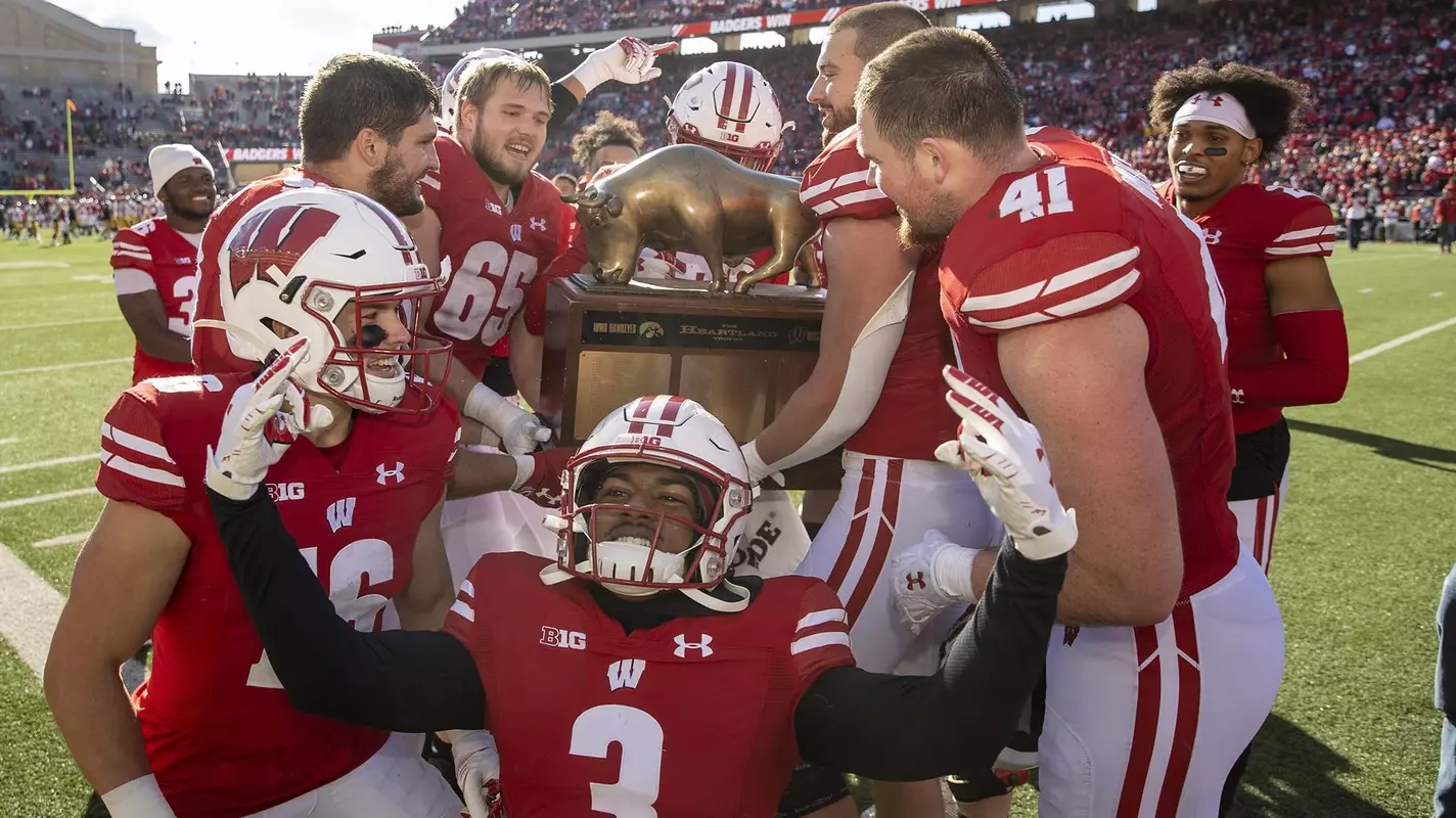 Football team celebrates with Heartland trophy after defeating Iowa 27-7 on October 30, 2021 at Camp Randall Stadium in Madison, Wis.