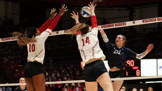 Devyn Robinson and Anna Smrek go up for a block against a PSU hitter.