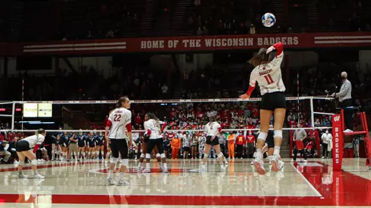 Izzy Ashburn serves up the ball.