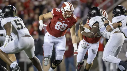 Wisconsin Badgers offensive lineman Tyler Beach (65) blocks during an NCAA college football game against the Army Black Knights, Saturday, Oct. 16, 2021, in Madison, Wis. The Badgers won 20-14. (Photo by David Stluka/Wisconsin Athletic Communications)