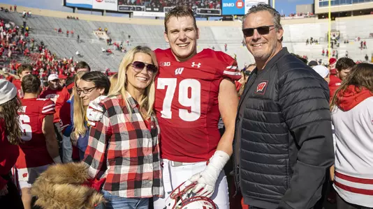 Wisconsin Badgers offensive lineman Jack Nelson (79) with his mother Sarah and his father Todd after an NCAA college football game against the Iowa Hawkeyes, Saturday, Oct. 30, 2021, in Madison, Wis. The Badgers won 27-7. (Photo by David Stluka/Wisconsin Athletic Communications)