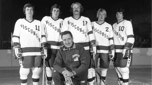 Bob Johnson with Wisconsin hockey student-athletes, including Bob Suter and Bob's sons Mark and Peter Johnson