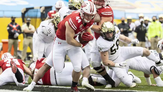 Wisconsin Badgers running back John Chenal (44) scores a touchdown with teammates during an NCAA college football game at the Duke’s Mayo Bowl against the Wake Forest Demon Deacons Wednesday, Dec. 30, 2020, in Charlotte, NC. The Badgers won 42-28. (Photo by David Stluka/Wisconsin Athletic Communications)