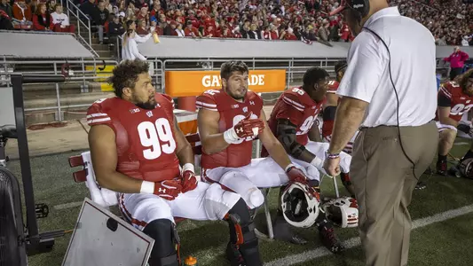 Wisconsin Badgers assistant coach Ross Kolodziej talks to defensive linemen Matt Henningsen (92) and Isaiah Mullens (99) during an NCAA college football game against the Army Black Knights, Saturday, Oct. 16, 2021, in Madison, Wis. The Badgers won 20-14. (Photo by David Stluka/Wisconsin Athletic Communications)