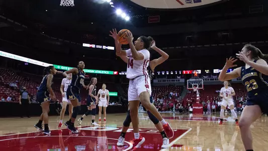 Krystyna Ellew drives to the basket against a Michigan defender.